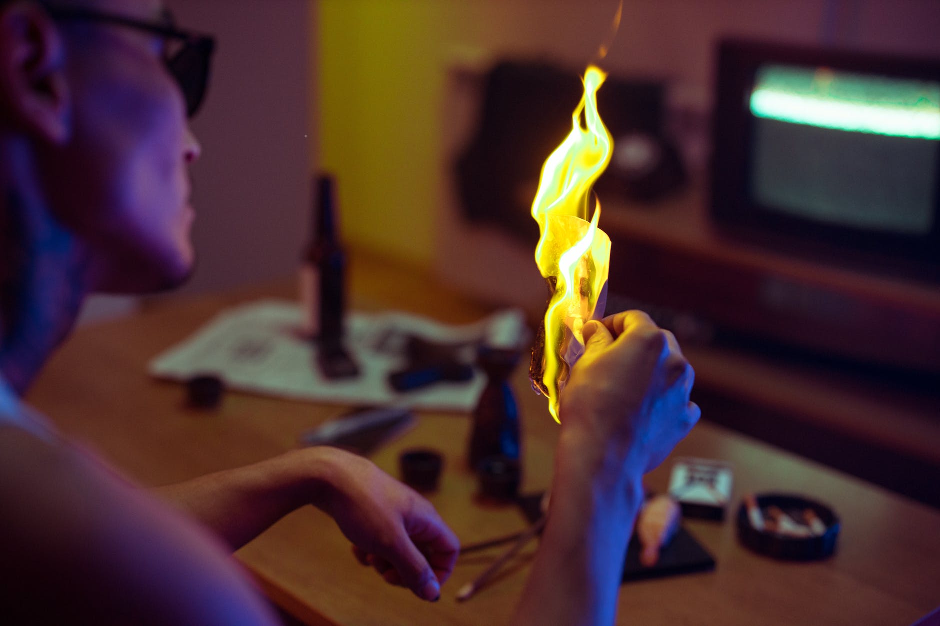 person holding yellow fire on table